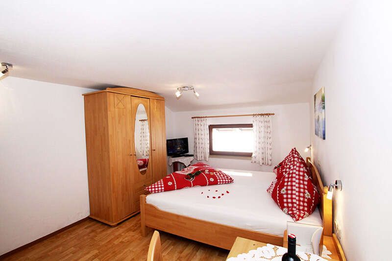 Room with double bed in the Pfandhof in Kaiserwinkl